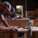 ZTUKOMN bench vise configured with electric grinder holder attachment.
