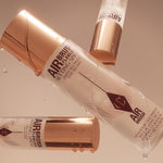 Professional makeup artist using Charlotte Tilbury setting spray