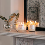 Neom 1 wick candle placed next to decorative room elements
