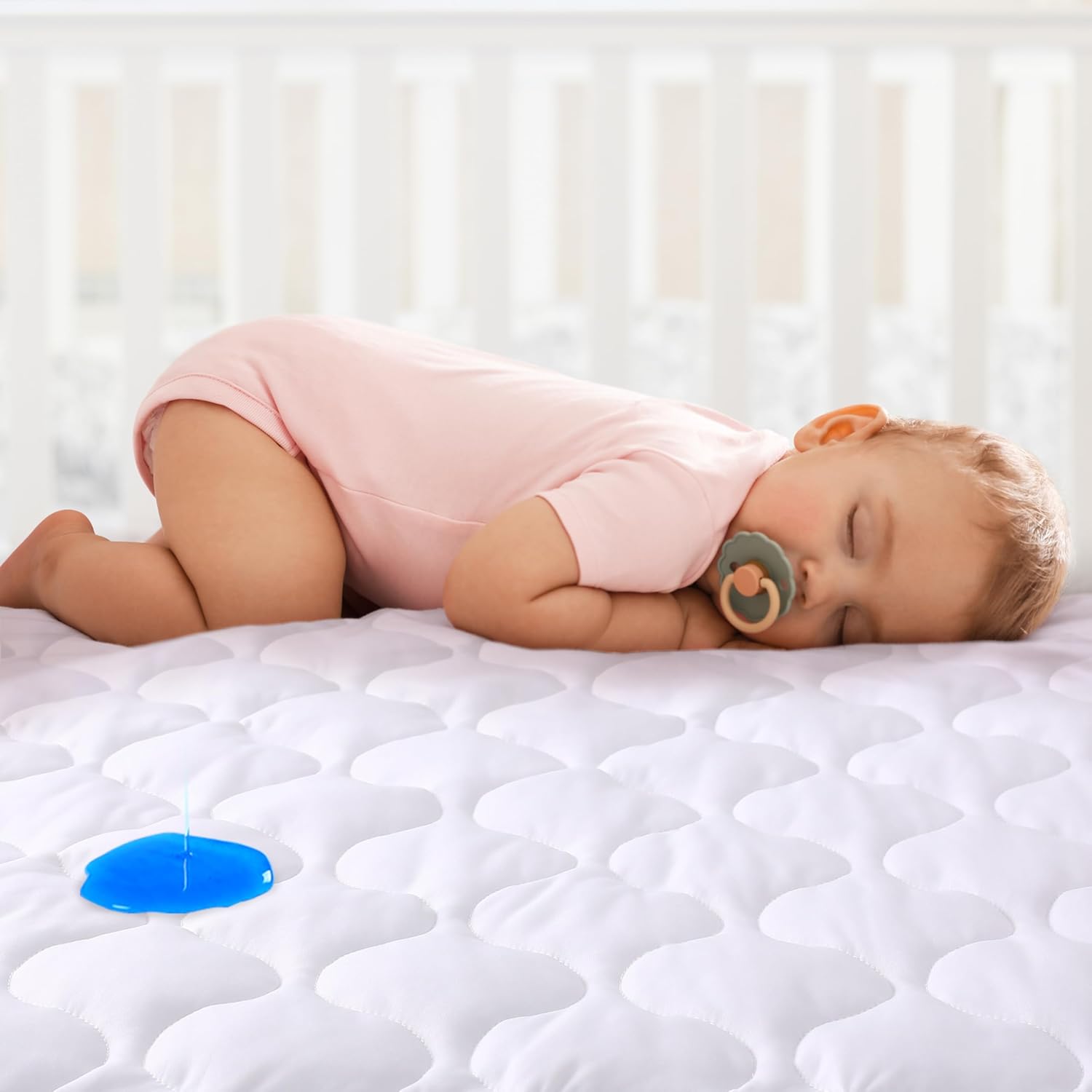 Yoofoss waterproof crib mattress protector front view showcasing the white quilted surface.