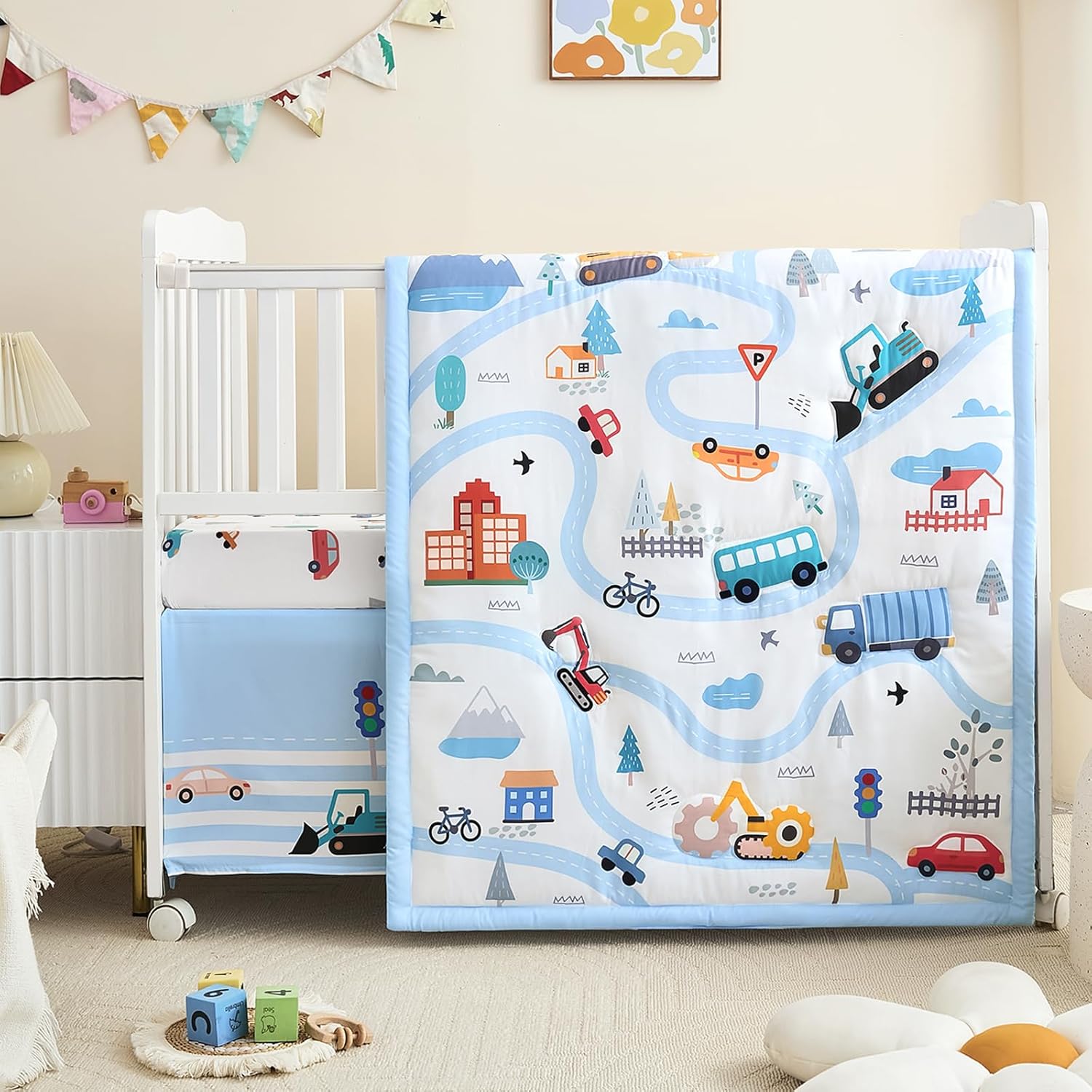 NacoMoco 3-Piece Crib Bedding Set front view featuring light blue vehicle print comforter and matching skirt