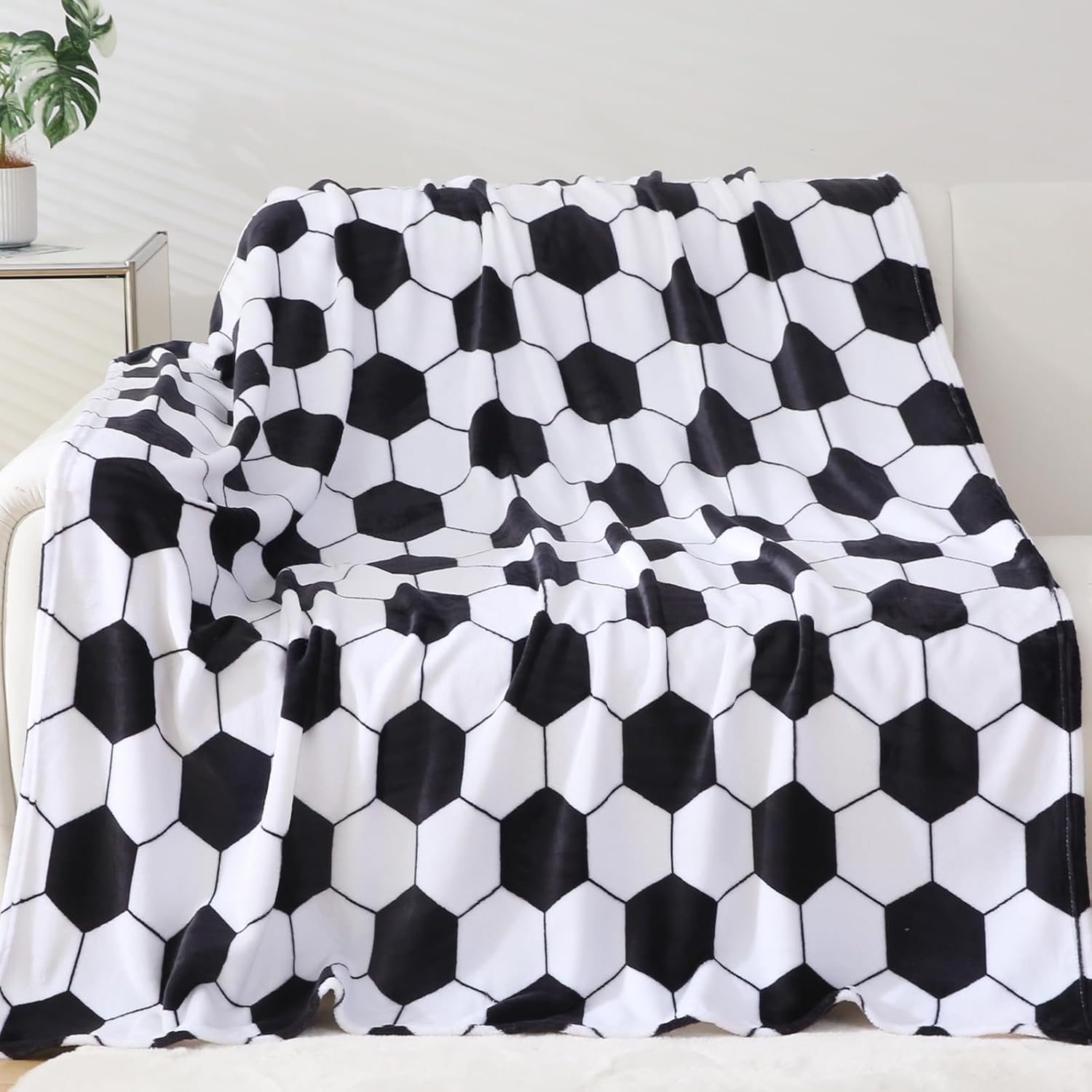 Niopos soccer blanket front view featuring classic black and white football print.
