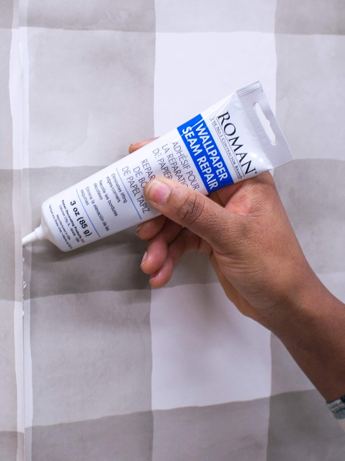 Roman 3 ounce wallpaper adhesive packaging and label display