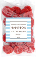 Bright red strawberry licorice spirals piled together showing the pinwheel texture