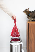 Premium red plastic pet waste bags showing suffocation hazard warning text.