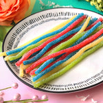 Colorful blue raspberry and lemon sour straws ideal for edible drink garnishes.
