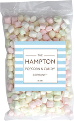 A bowl filled with pink, yellow, and blue soft after-dinner pillow mints for event decoration.