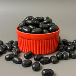 Close up view showing the glossy shell texture of licorice candies