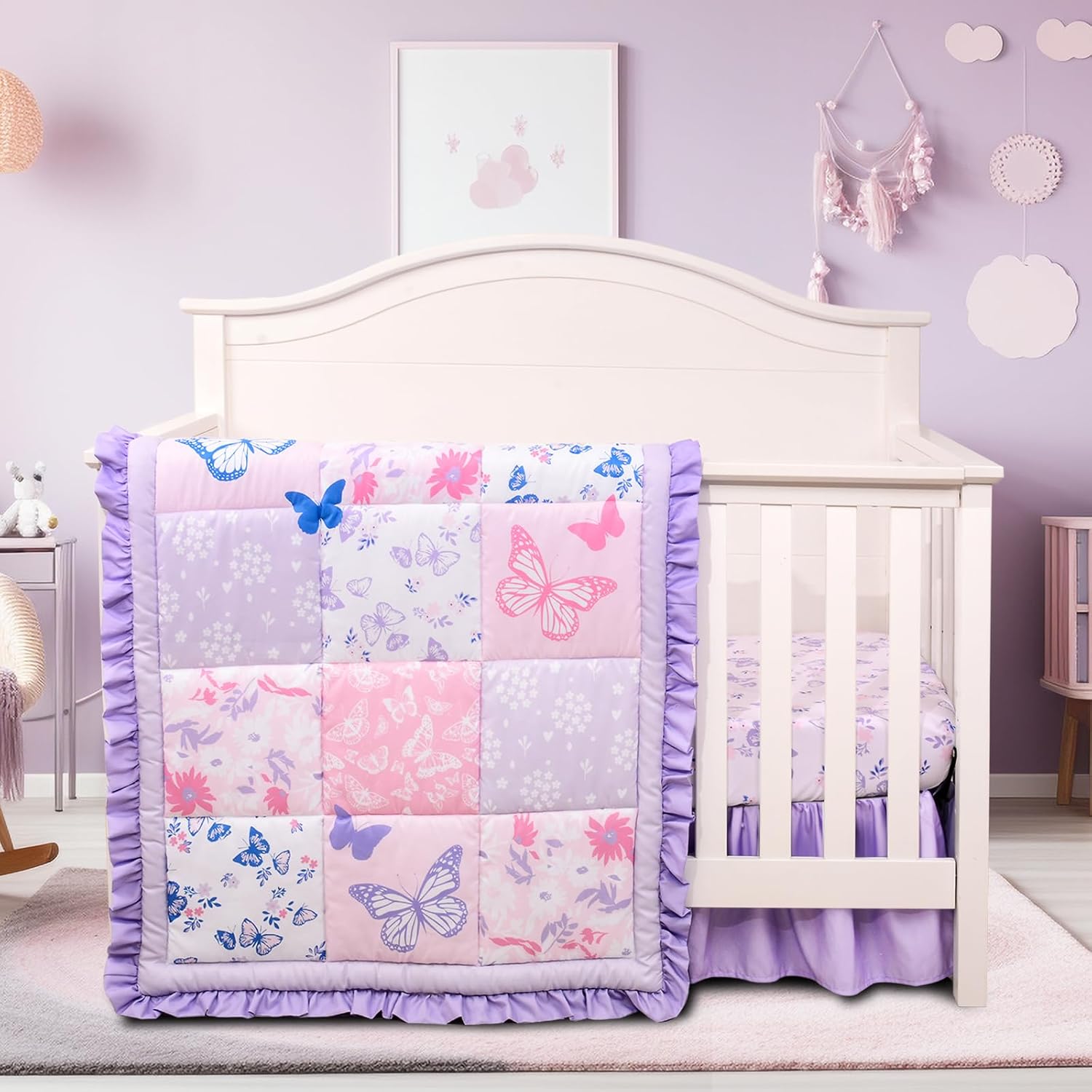 Cloele girls floral butterfly baby bedding set front view showcasing the purple comforter and fitted sheet on a standard nursery crib.
