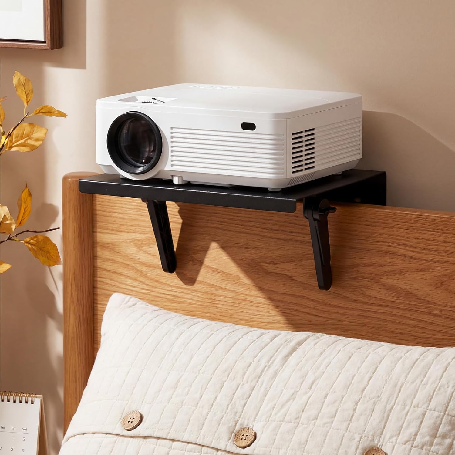 ElaraBerry no drill metal projector mount front view hanging on a modern sofa backrest.