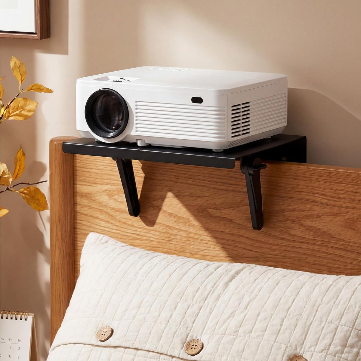 ElaraBerry no drill metal projector mount front view hanging on a modern sofa backrest.
