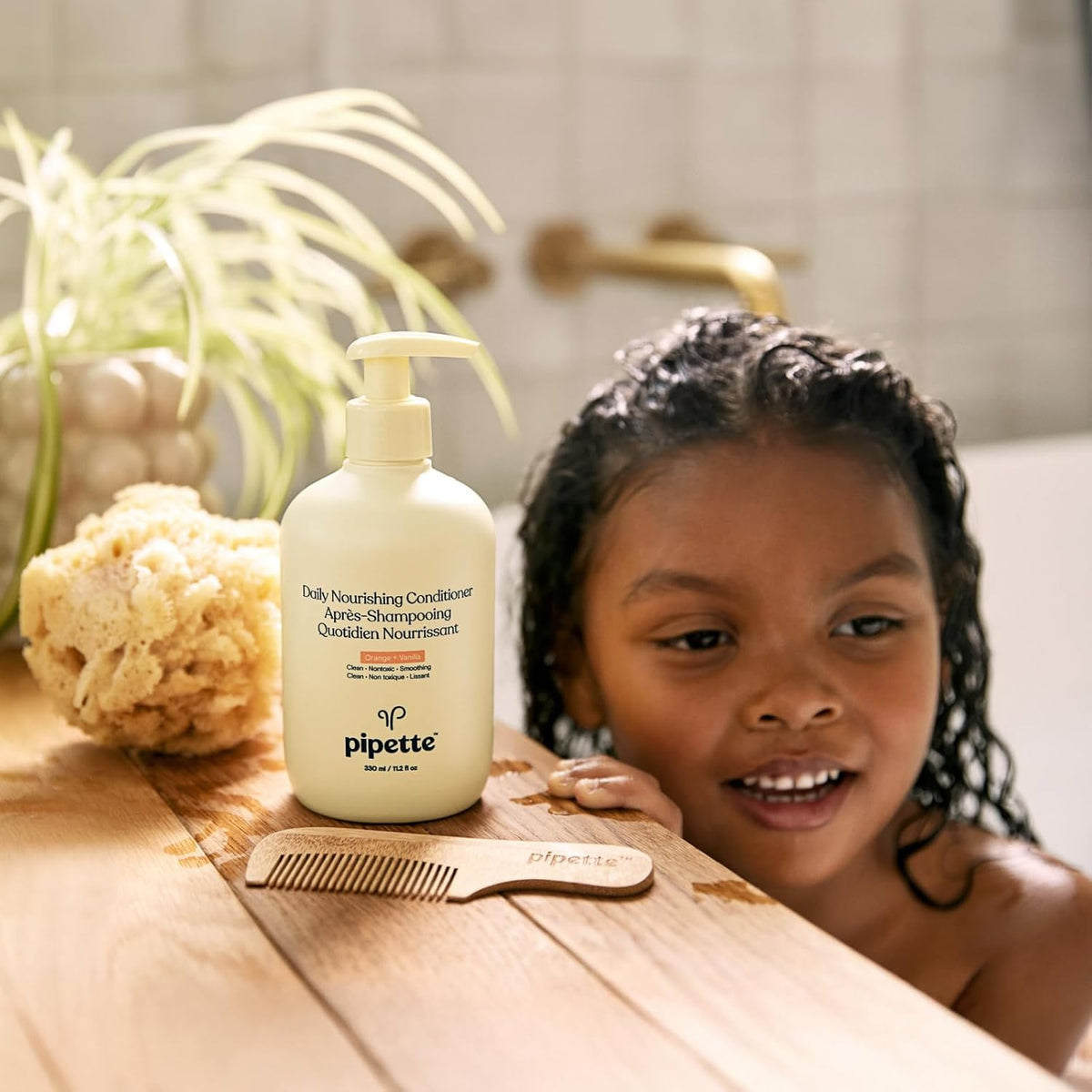 Pipette hair conditioner bottle next to squalane ingredients