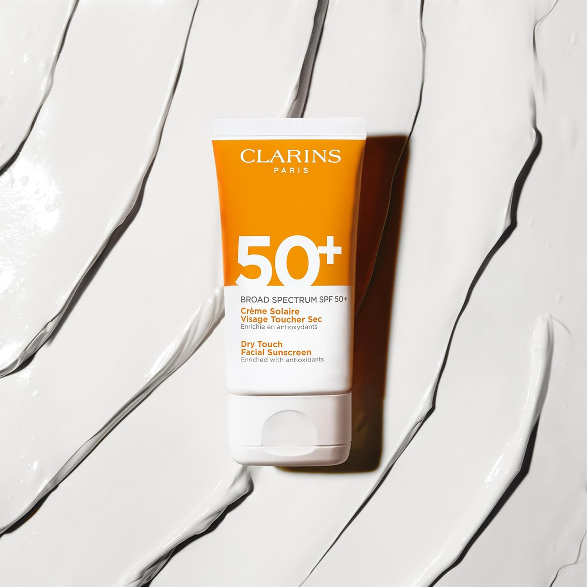 Clarins dry touch sunscreen applied on face model