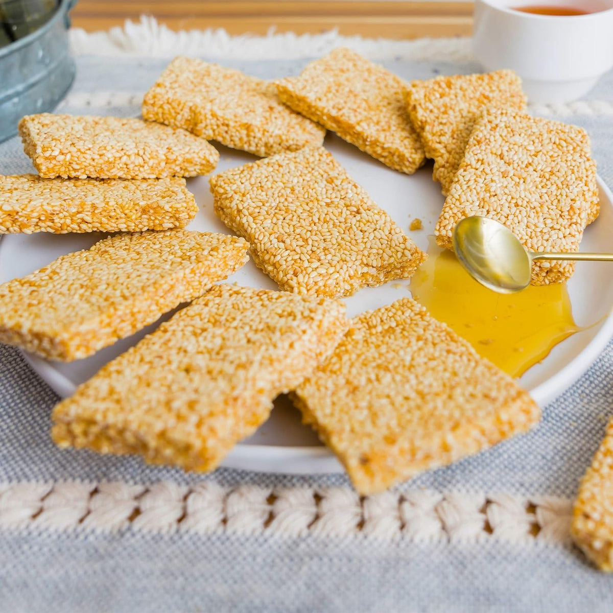 Top down shot of premium plant based sesame seed snack bars highlighting their crispy texture.