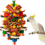 YIXUND natural corn cob and loofah slices bird chew toy front view hanging inside a cage.