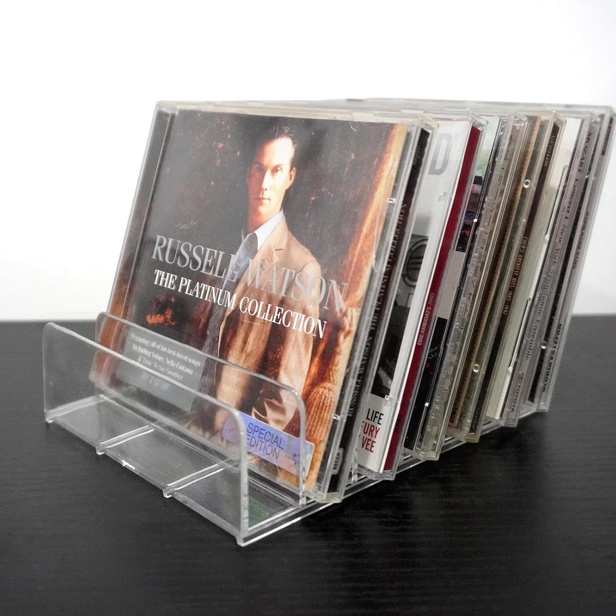 MayRecords acrylic CD display rack front view showing clear tabletop media storage