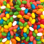 A handful of glossy multi colored chewy candies showcasing their vibrant outer shells.