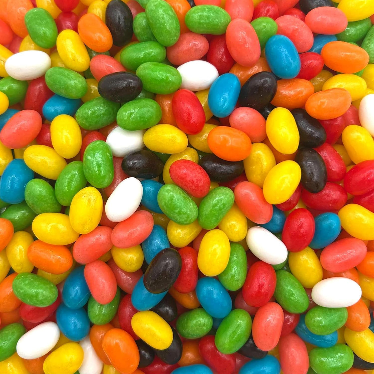 A handful of glossy multi colored chewy candies showcasing their vibrant outer shells.