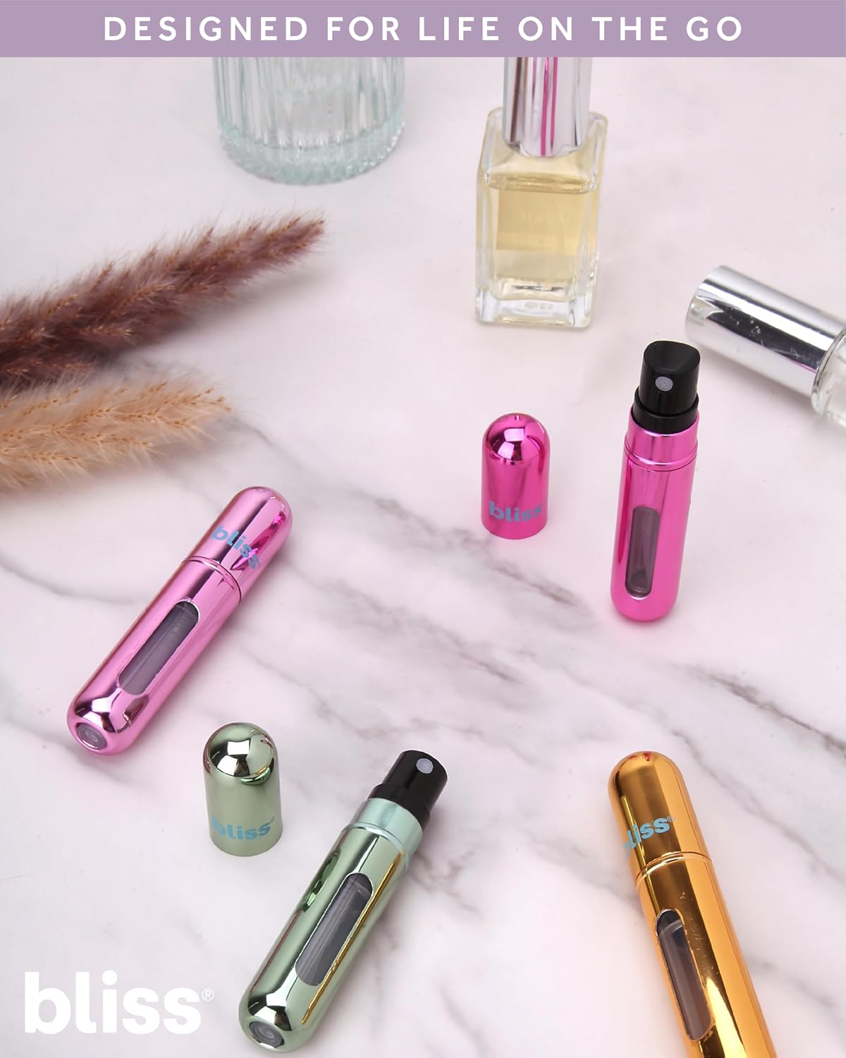 Bliss TSA approved travel toiletries bottles showing fine mist spray.