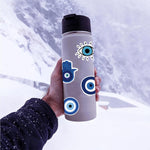 Close-up view of blue evil eye and hamsa decal details
