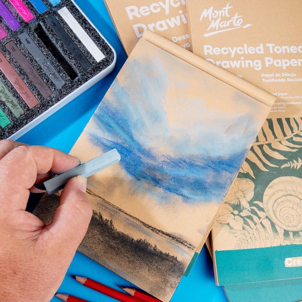 Mont Marte sketch pad stacked with art supplies