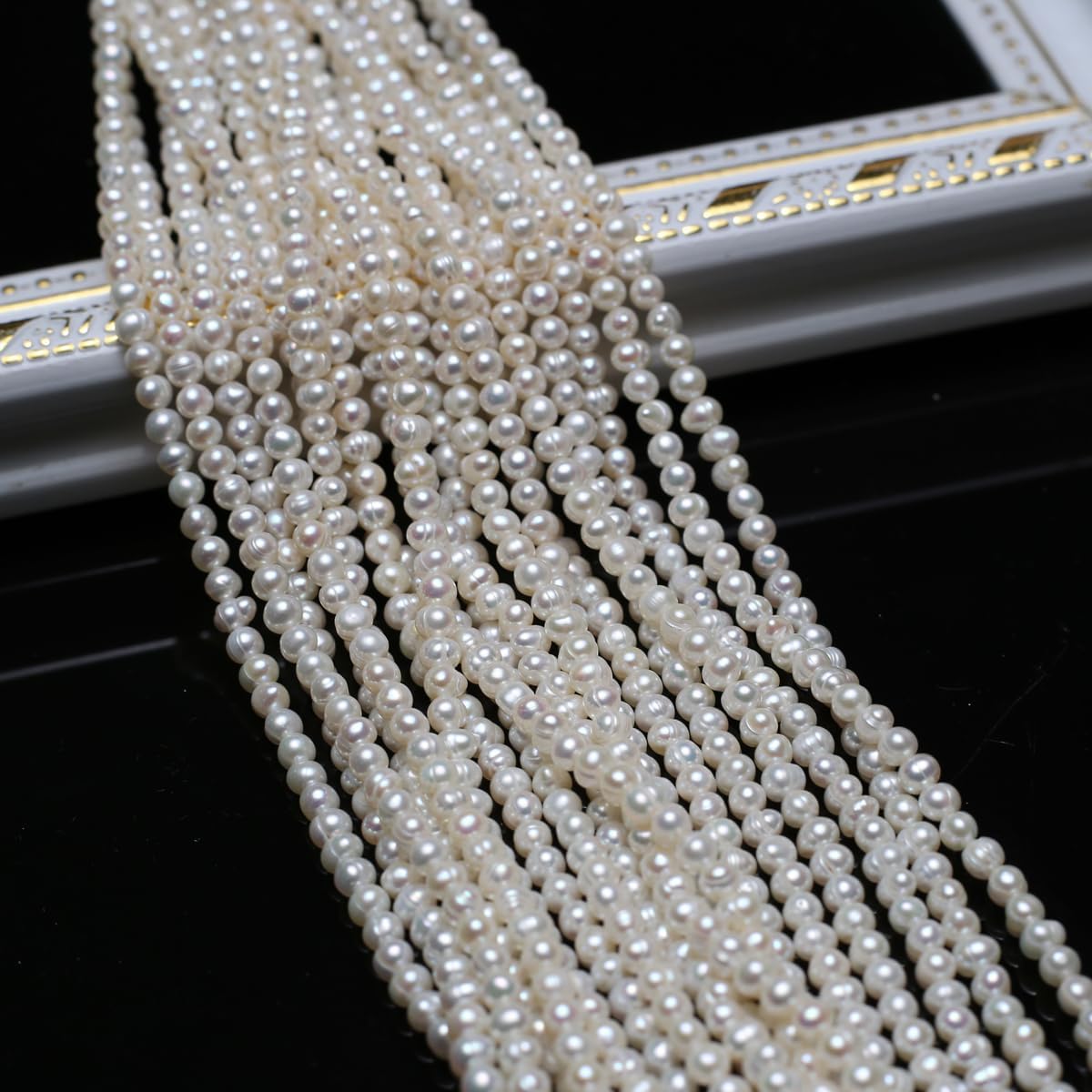 Close up of 3-4mm white freshwater cultured pearls