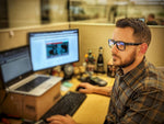 Magid Y50 safety glasses being held to demonstrate lightweight design