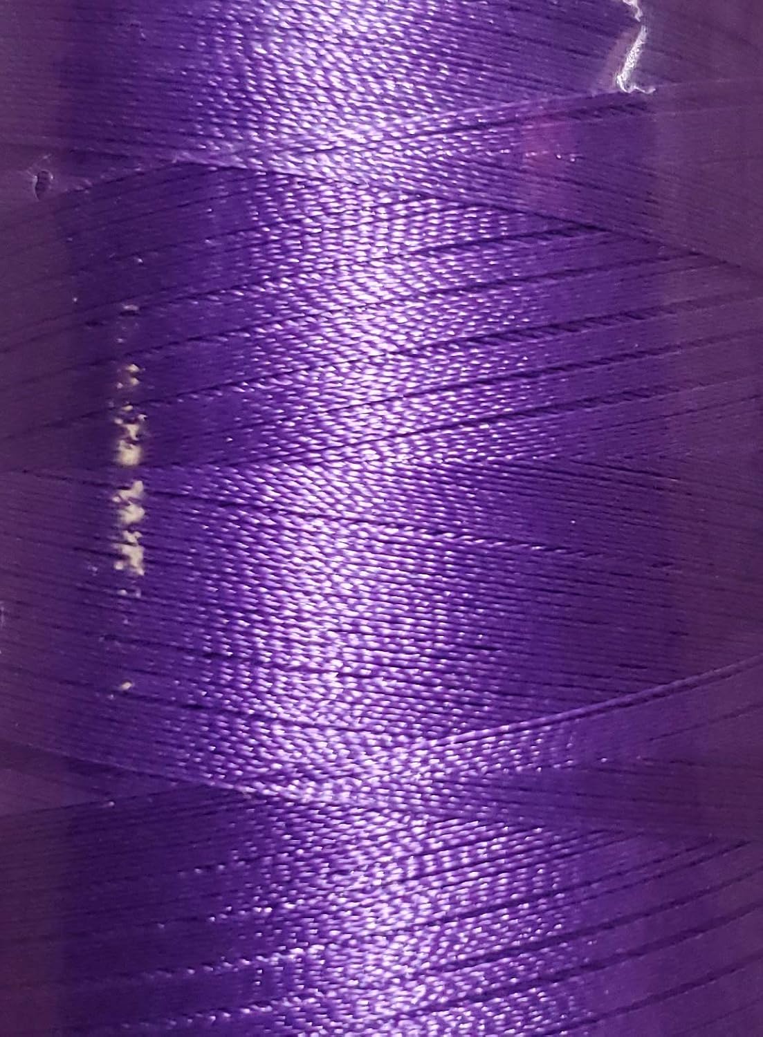Close up of Majestic Purple polyester embroidery thread spool texture