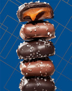 Sanders sweet and salty milk chocolate caramels displayed open showing the generous quantity inside the tub.