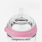 Comotomo pink silicone baby bottle showing soft squeezable body