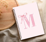 Cute pink hardcover diary in a backpack setup
