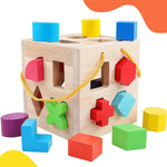 QZMTOY Wooden Shape Sorter Toy front view showing the natural solid wood cube with geometric blocks.