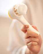 Aprilskin dual-sided facial brush showing the soft silicone exfoliation pad side.