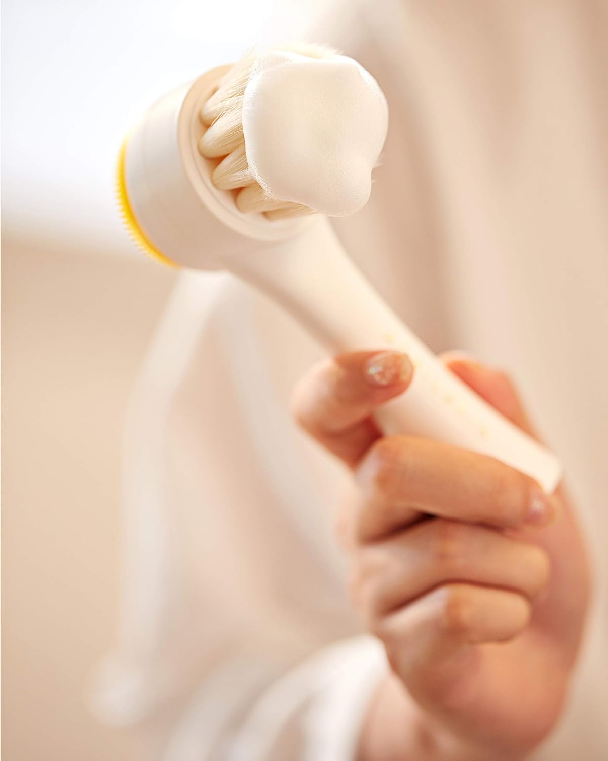 Aprilskin dual-sided facial brush showing the soft silicone exfoliation pad side.