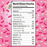 Pink and white capsule shaped candy pieces spilling out of bulk bag