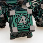 Close-up of D20 metal dice from ORIFANTOU green debris set
