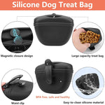 Two puppy training clickers with wrist straps in dark green and black colors.