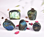 Jic Gem decorative reiki stone positioned on wooden desk surface.