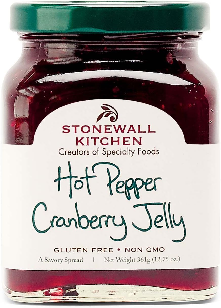Stonewall Kitchen gourmet red pepper spread applied onto a classic cheese board