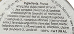 Burt's Bees hand salve tin next to natural ingredients