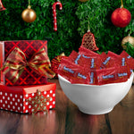 Munchique strawberry flavored chewy candy ropes spilling out of a transparent party bowl.