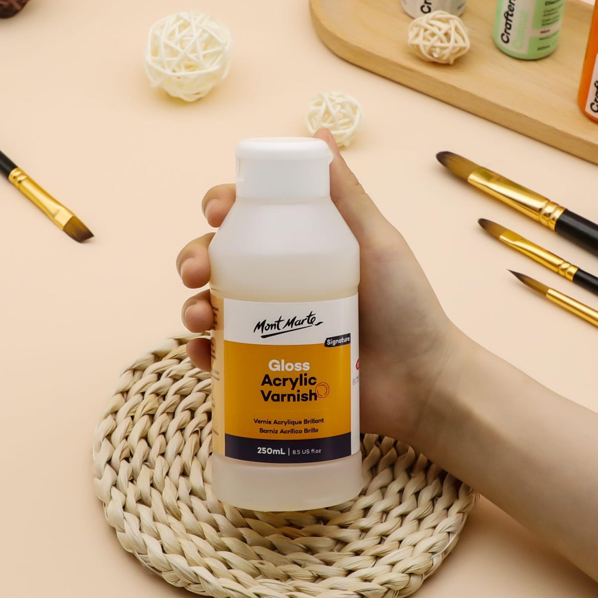 Mont Marte 250ml varnish bottle displayed with an artist paintbrush