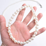 Glossy white pearl beaded pet accessory close up