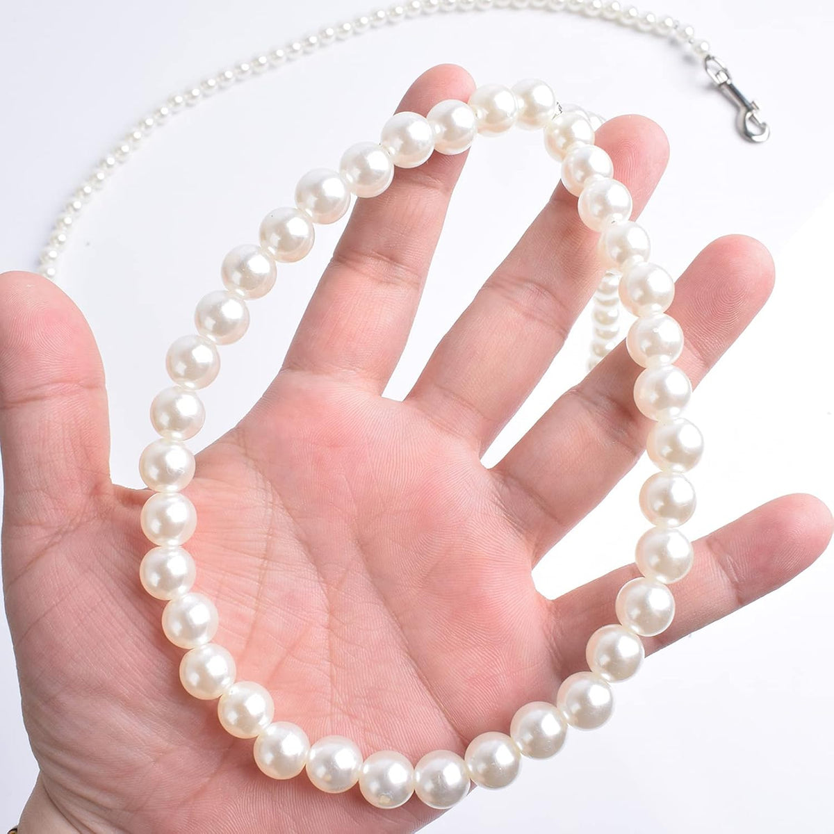 Glossy white pearl beaded pet accessory close up