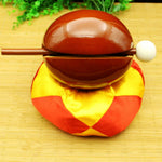 Close-up of camphorwood fish-shaped carving on zen drum