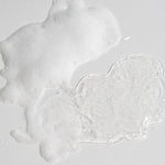 Hypoallergenic Celimax sensitive skin face wash bottle standing upright next to water droplets.