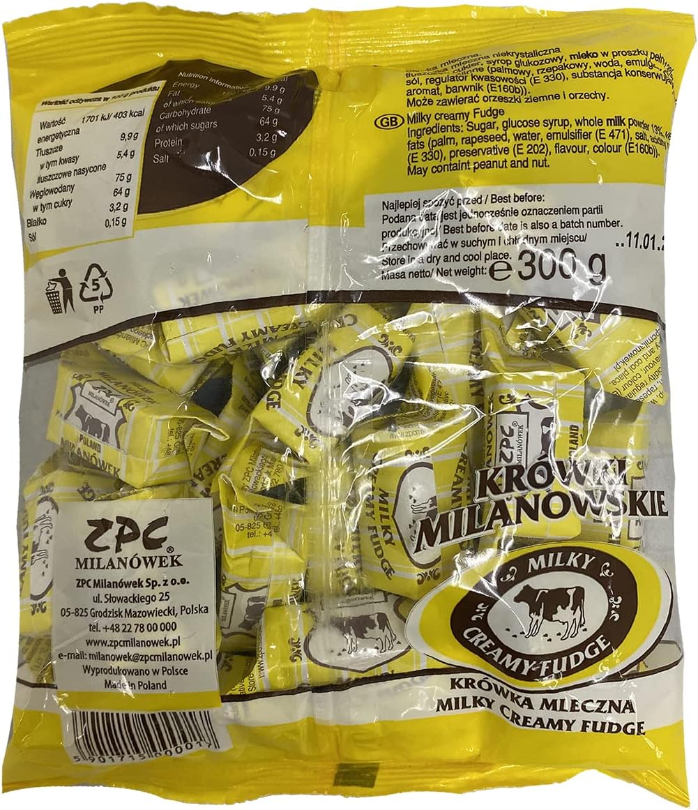 Individually wrapped Polish cream fudge candies scattered next to the original Krowki Milanowskie packaging.