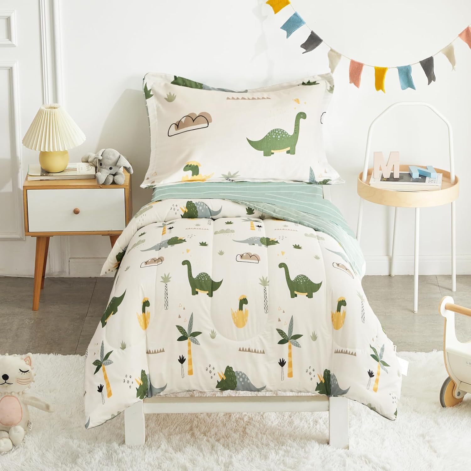 Joyreap 4 piece cotton dinosaur toddler bedding set laid out cleanly on a standard kids bed front view