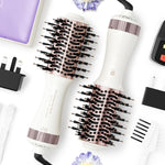 Madremía travel dual voltage hair dryer brush front view showing the sleek nacre white and rose gold titanium barrel