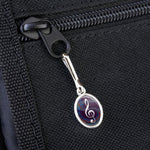 Double-sided resin-topped music note charm close-up